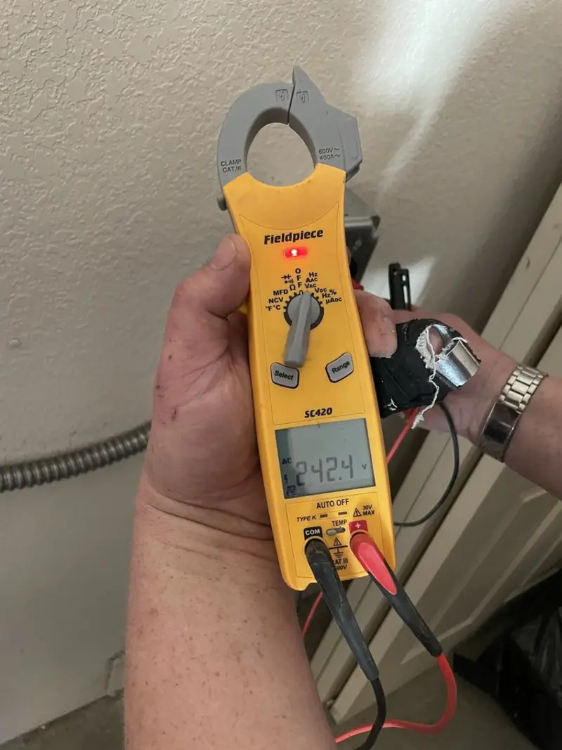 Voltage testing with clamp meter during Recessed Lighting Installation in Canton